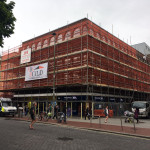 Large building surrounded by scaffold